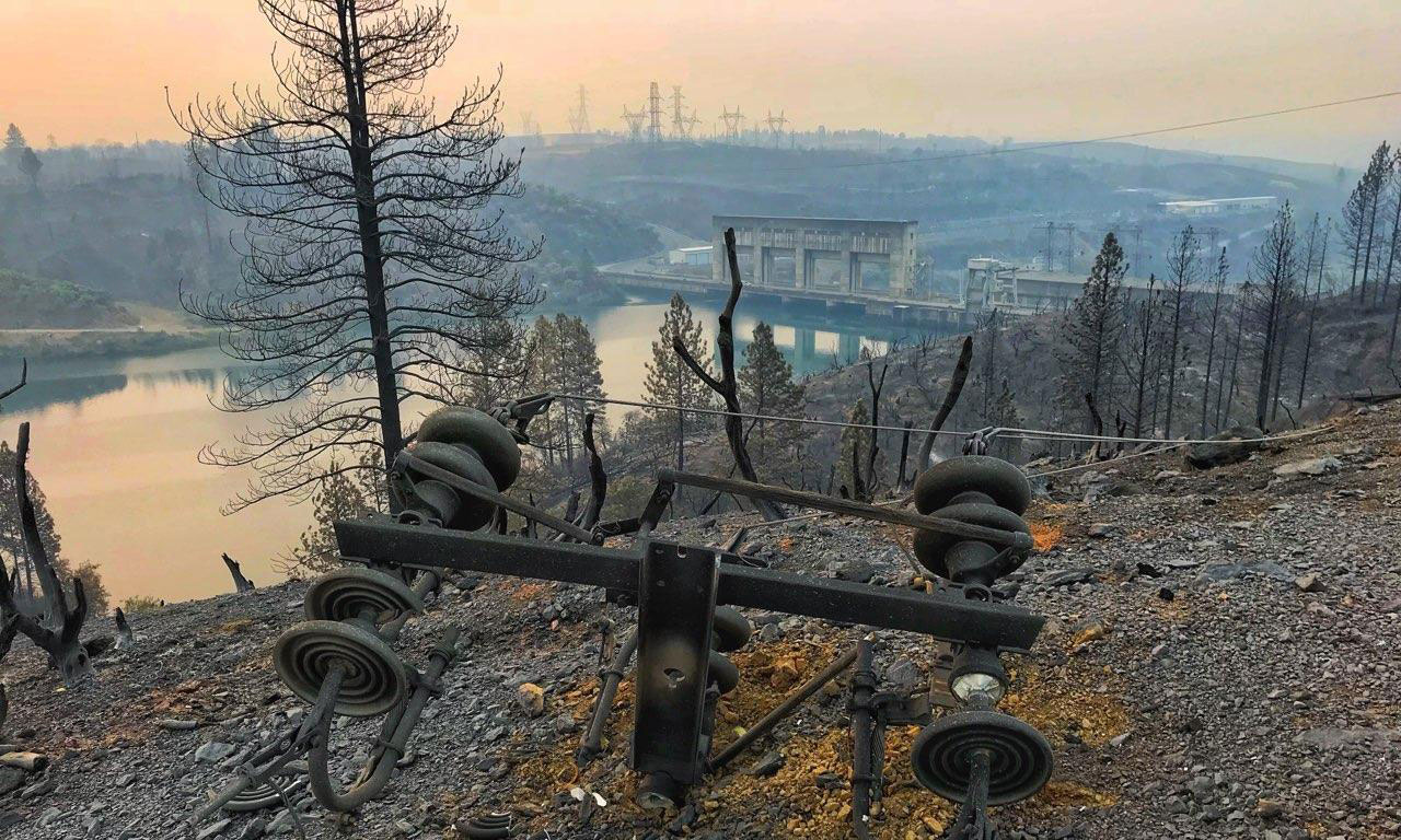 The aftermath of a wildfire, with resevoir in the background