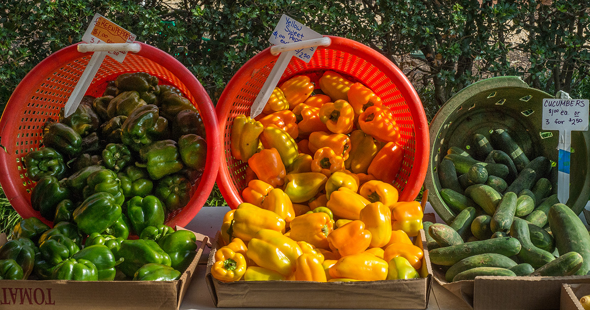 Peppers and cucumbers at a farmers market