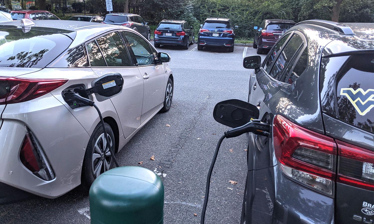Two cars charging at a public parking lot of a park in the city of Cambridge, MA