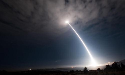 A missile being launched into the night sky.