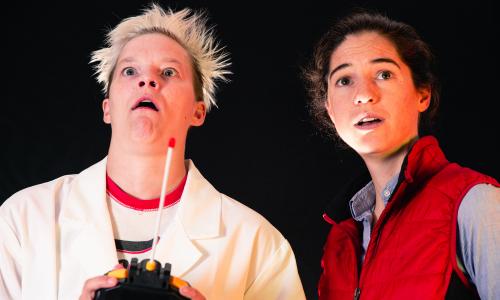 A scientist and teenager stare in wonder at the flames left behind by a car that traveled at 88 miles per hour