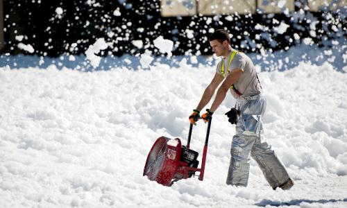 Worker using blower on firefighting foam 