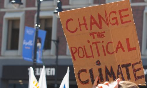 Sign at rally saying 'change the political climate'