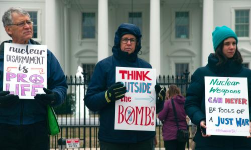 Man and two women protest nuclear weapons outside White House