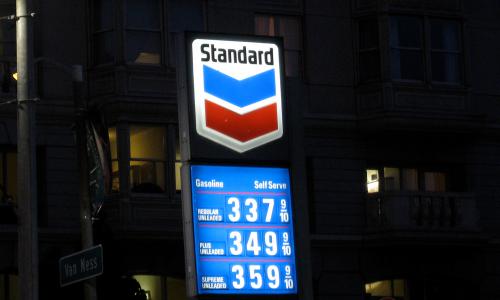 Backlit Chevron sign at night.