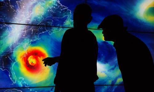 Two people looking at hurricane