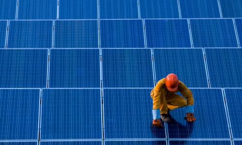 Person working on solar panels