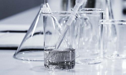 Beakers of chemicals laid out on a table.