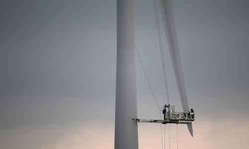 Workers on a ginormous wind turbine