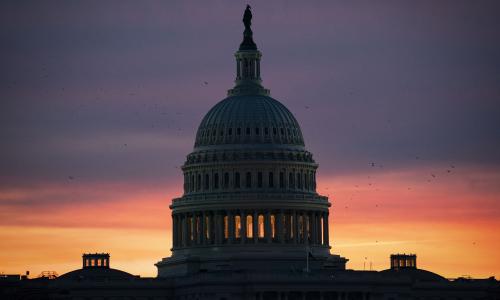 The US Capitol building against a dark sky.
