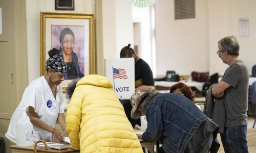 people signing in to vote at a polling place