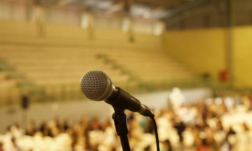 a microphone with an auditorium in the background