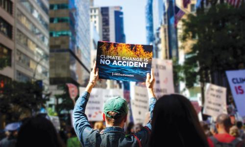 A person holding a protest sign