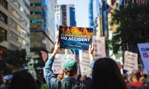 Thumbnail of a person holding a protest sign