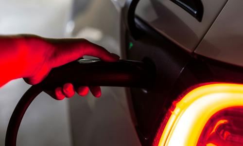 person charging an electric vehicle (EV)