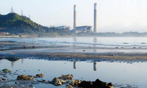 A power plant next to a river.