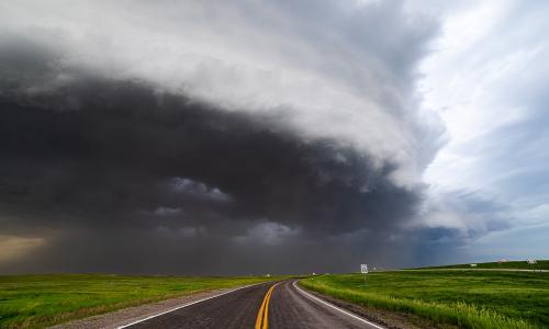Storm clouds over a road.