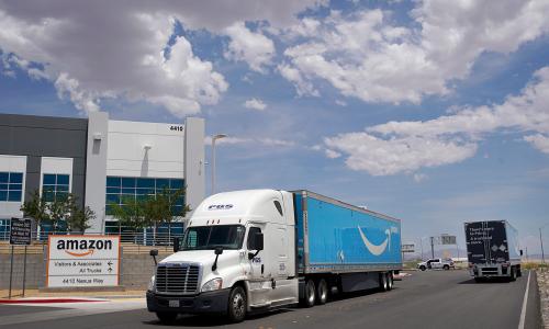  One Amazon truck leaves as another enters the Amazon regional distribution center in Las Vegas, Nevada. 
