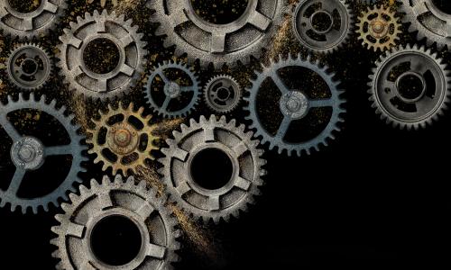 An illustration of gears covered in sand.