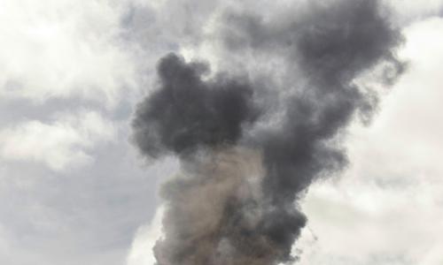 Dark smoke from a factory pipe.