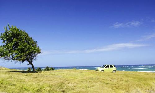 A car parked near the ocean.